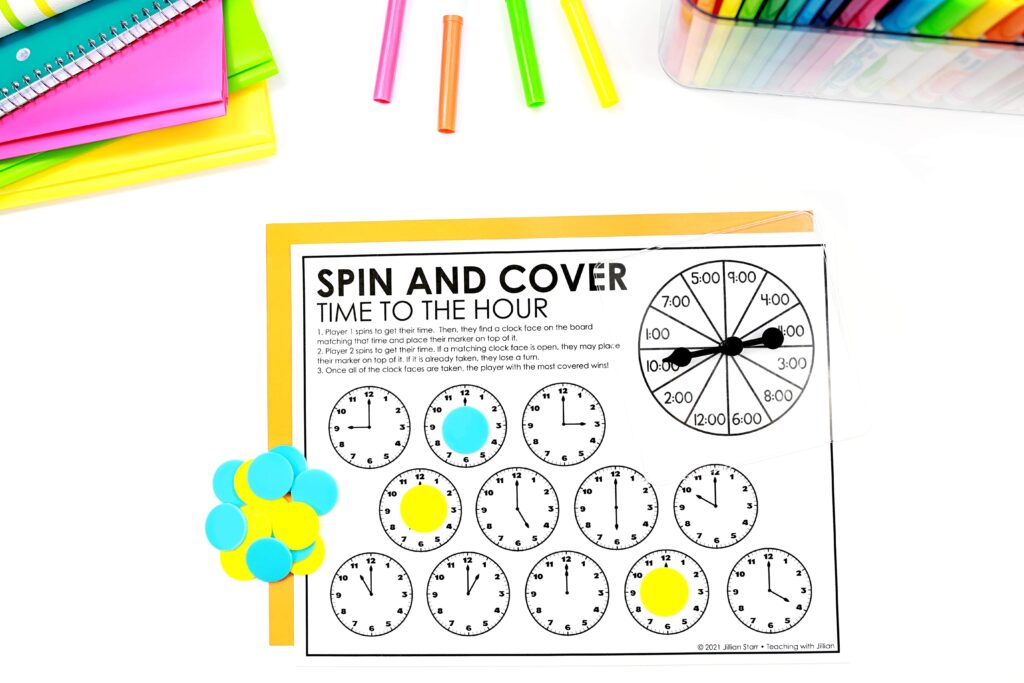Telling time to the hour game called spin and cover. Game chips and spinner are included to help show how the game is played.