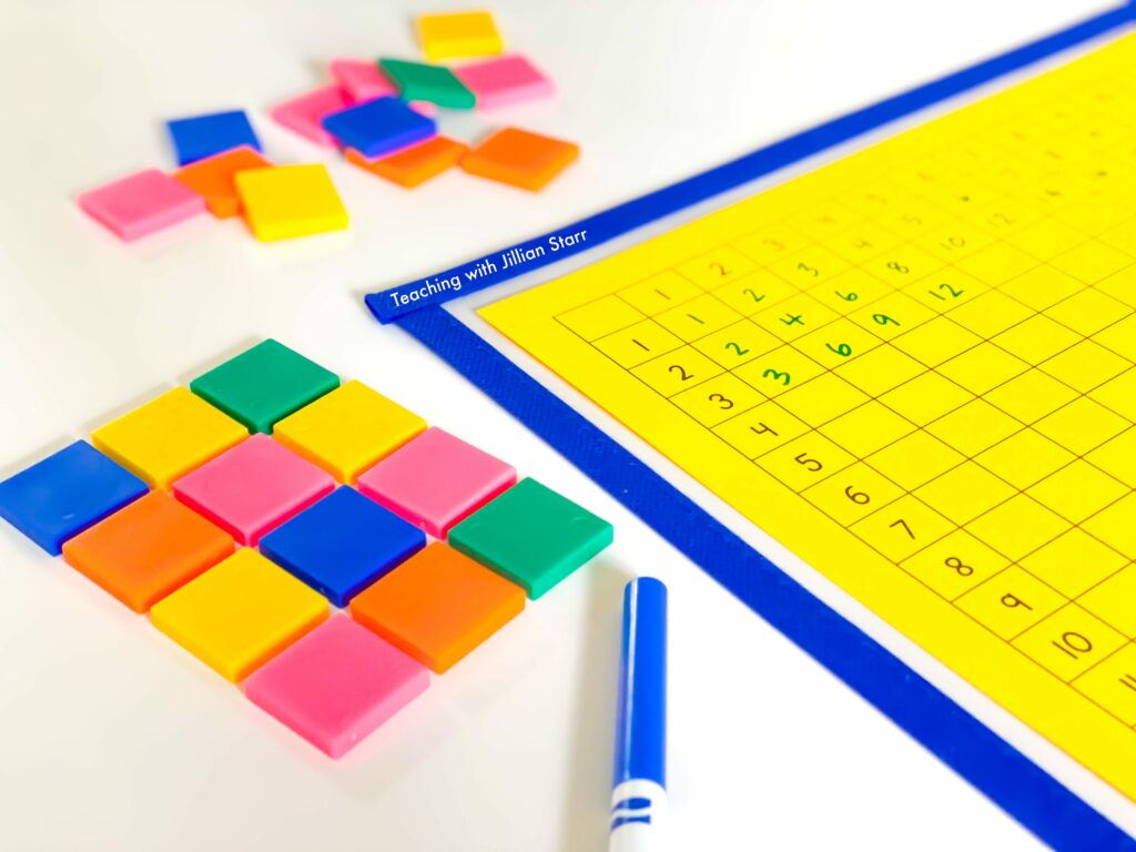 using a blank multiplication table to build conceptual understanding - shows an array built out of square tiles and a partially filled out multiplication table